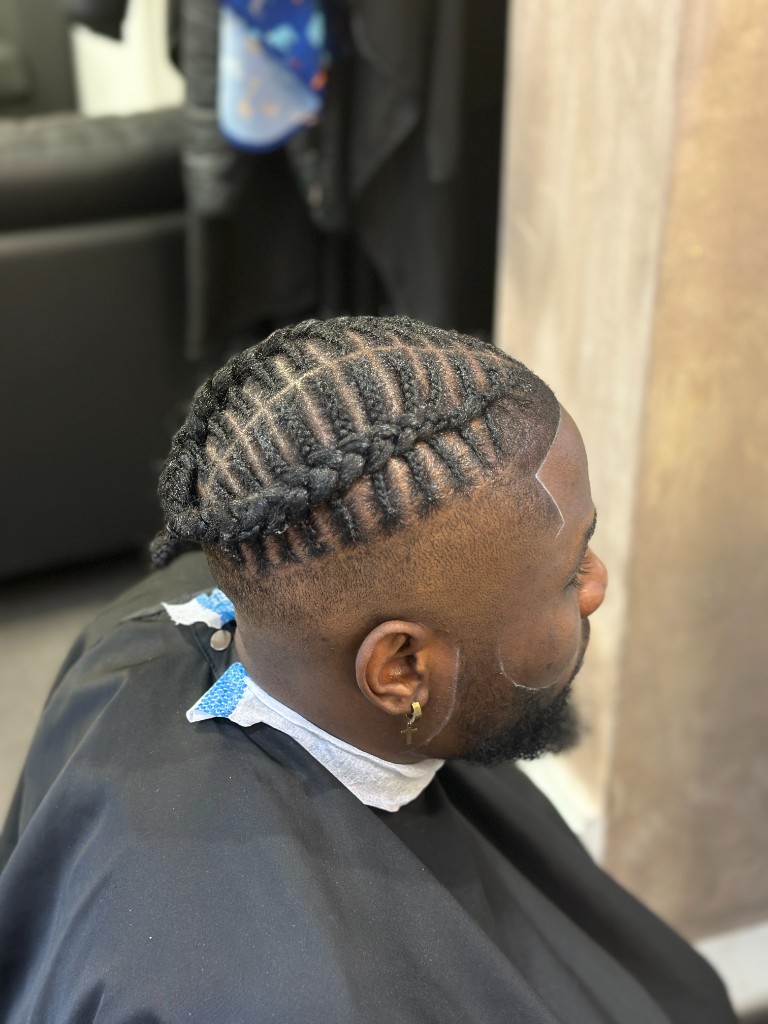 Cornrow braids with a sharp skin fade and lineup