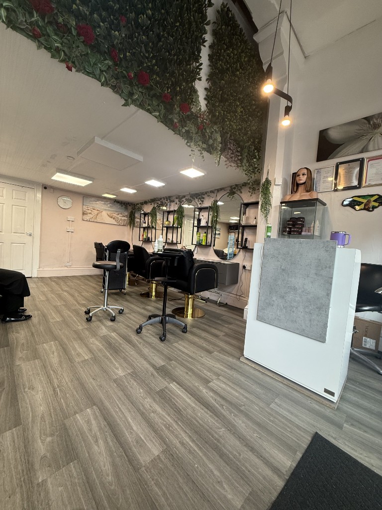 Salon floor with styling chairs and greenery wall